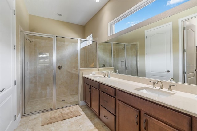 bathroom featuring tile patterned floors, vanity, and an enclosed shower