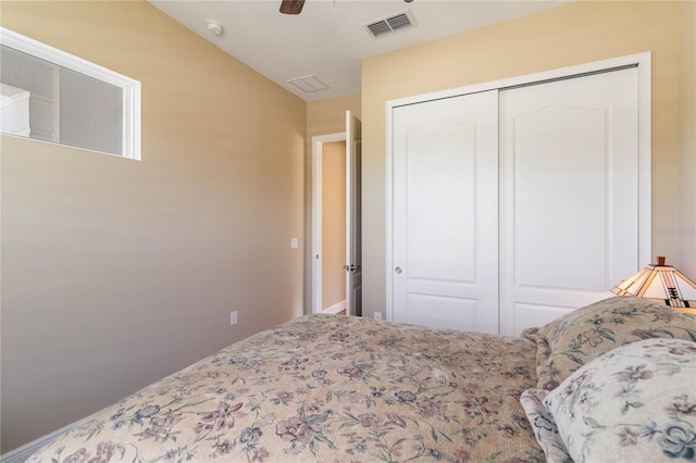 bedroom with ceiling fan, lofted ceiling, and a closet