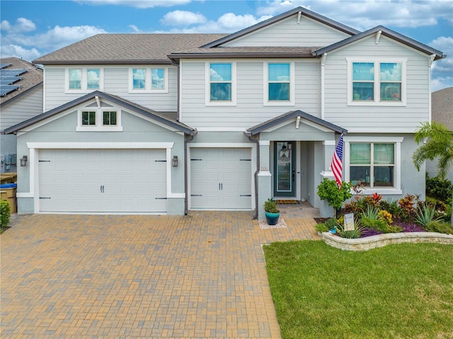 view of front of house featuring a garage and a front yard