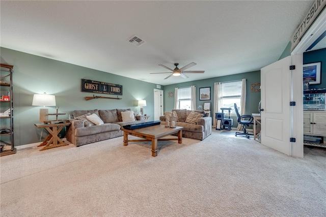 carpeted living room featuring ceiling fan