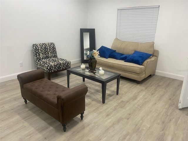 living room featuring light wood finished floors and baseboards