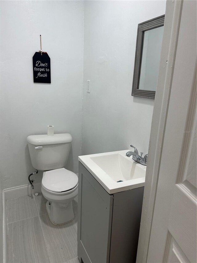 half bathroom with toilet and vanity