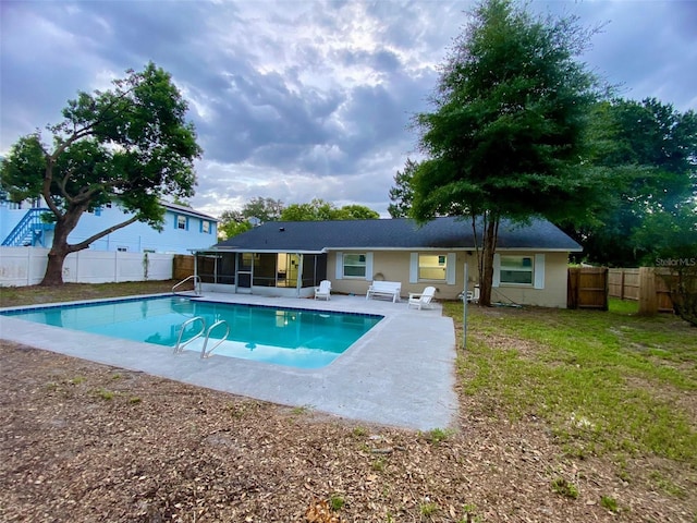 view of pool featuring a patio, a fenced backyard, a sunroom, and a fenced in pool