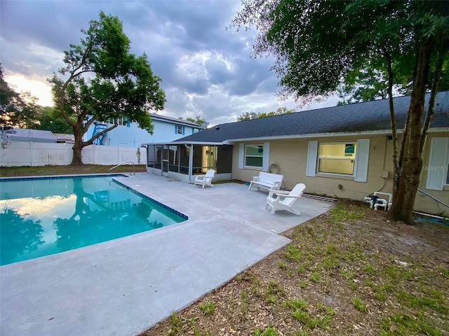 view of pool featuring a fenced in pool, a sunroom, a patio, and fence