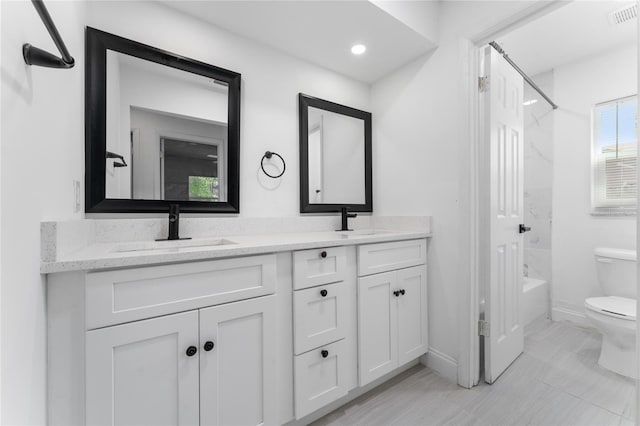 full bath featuring visible vents, double vanity, a sink, and toilet