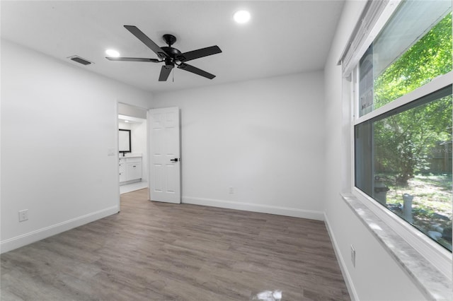 unfurnished bedroom featuring recessed lighting, wood finished floors, visible vents, and baseboards