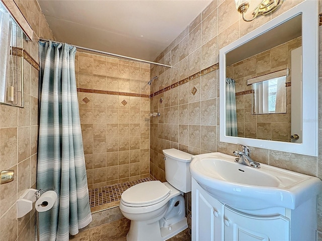 bathroom featuring tile walls, vanity, toilet, and a shower with shower curtain