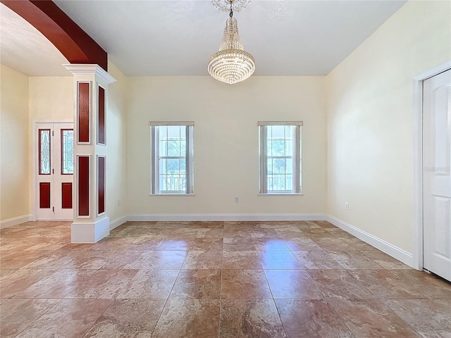 empty room with ornate columns and a healthy amount of sunlight