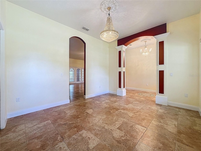 empty room with an inviting chandelier