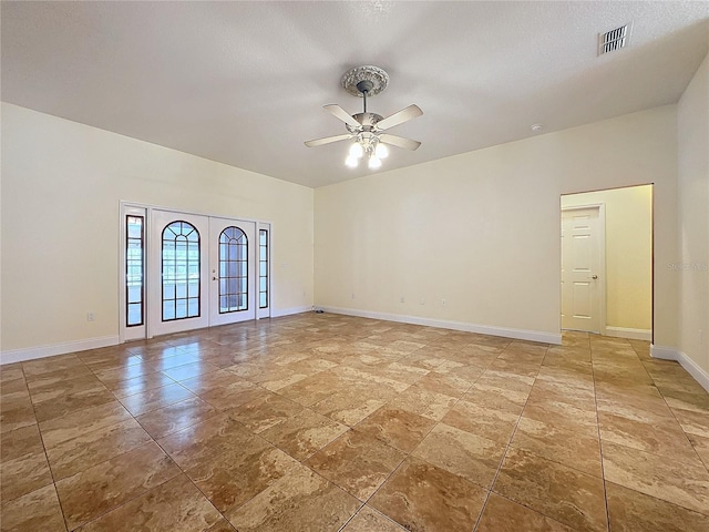 unfurnished room with french doors and ceiling fan