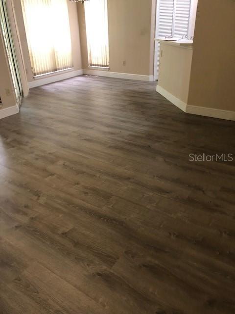 spare room featuring dark wood-type flooring