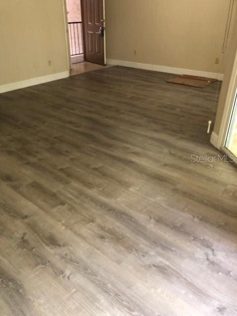 empty room with hardwood / wood-style flooring