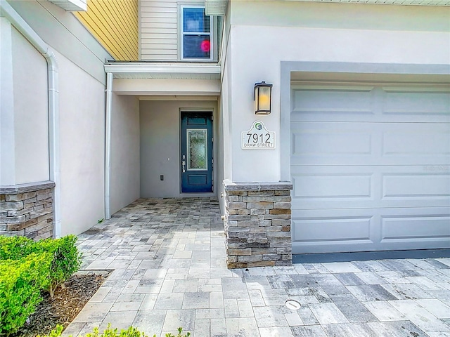 view of exterior entry with a garage