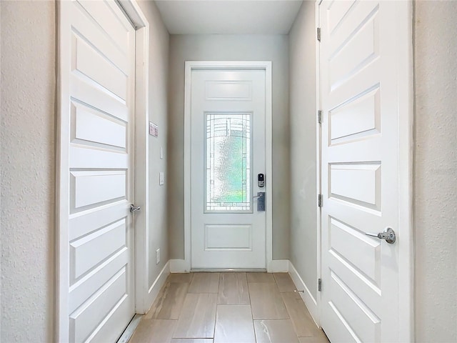 doorway to outside featuring light tile patterned floors