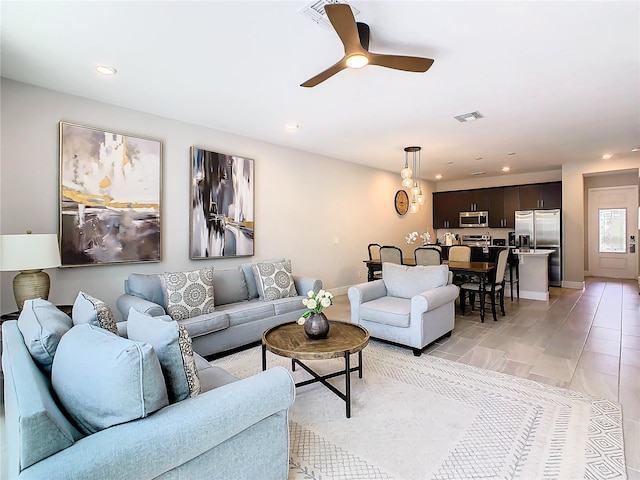 living room with light tile patterned flooring and ceiling fan