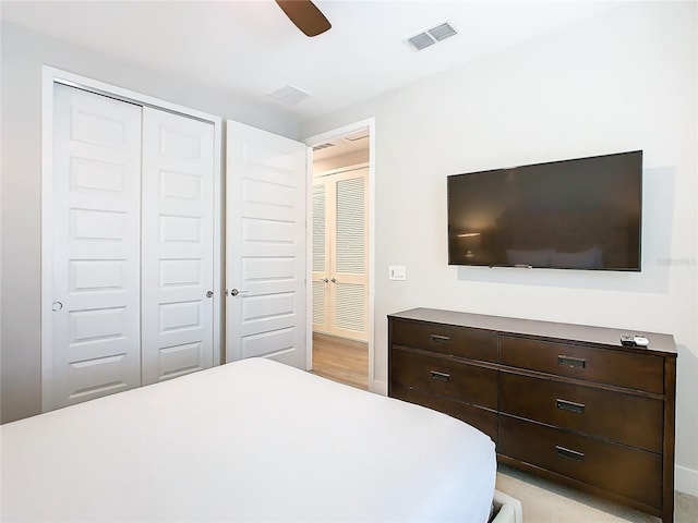 bedroom with ceiling fan and a closet