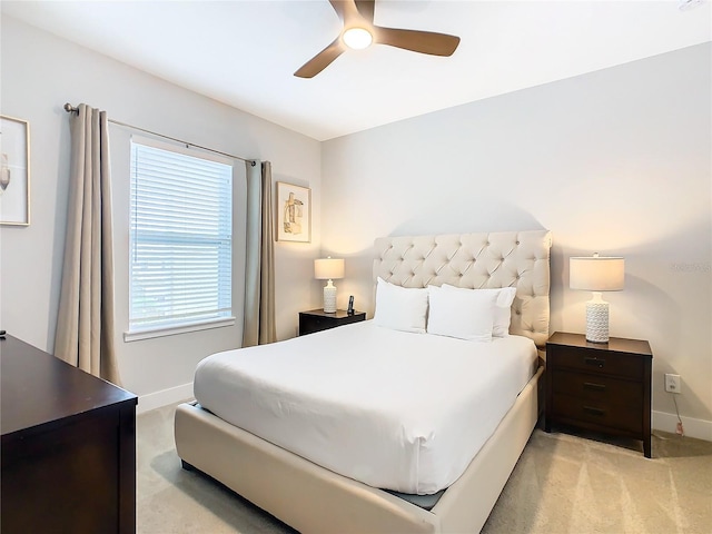 bedroom featuring light carpet and ceiling fan