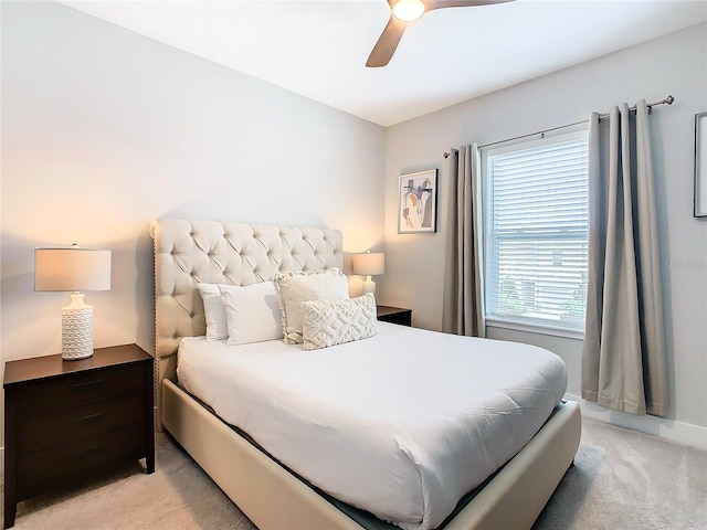 bedroom featuring light colored carpet and ceiling fan