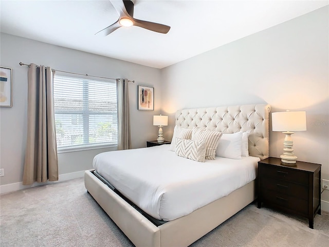 bedroom featuring light carpet and ceiling fan