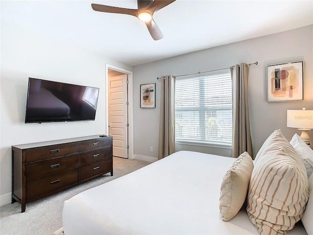 bedroom featuring ceiling fan and light colored carpet