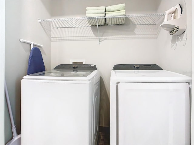 laundry room with washing machine and clothes dryer