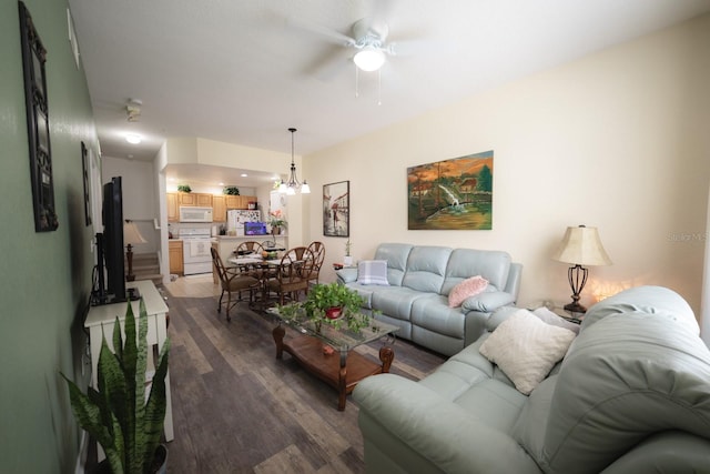 living room featuring ceiling fan with notable chandelier and wood-type flooring