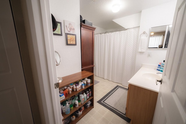 bathroom featuring tile patterned flooring and vanity