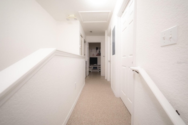 hall with light colored carpet