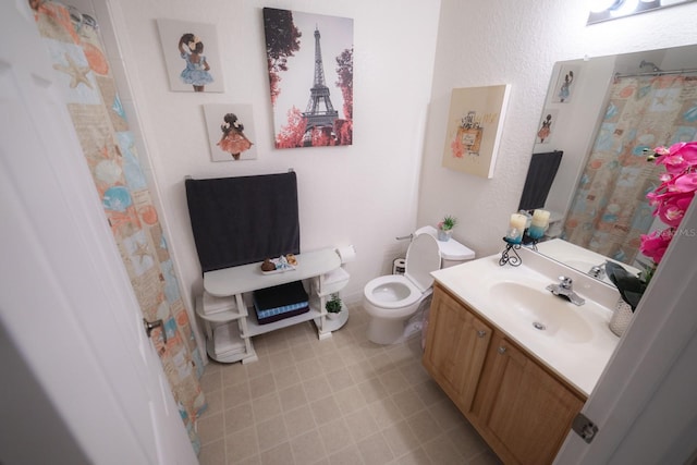 bathroom with vanity, toilet, and tile patterned floors