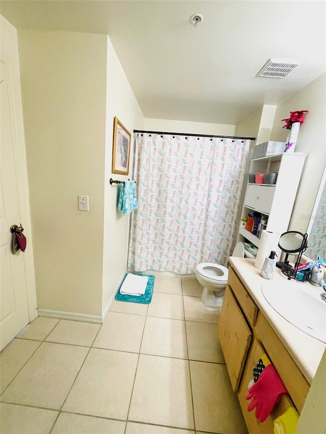 bathroom featuring vanity, tile patterned flooring, and toilet