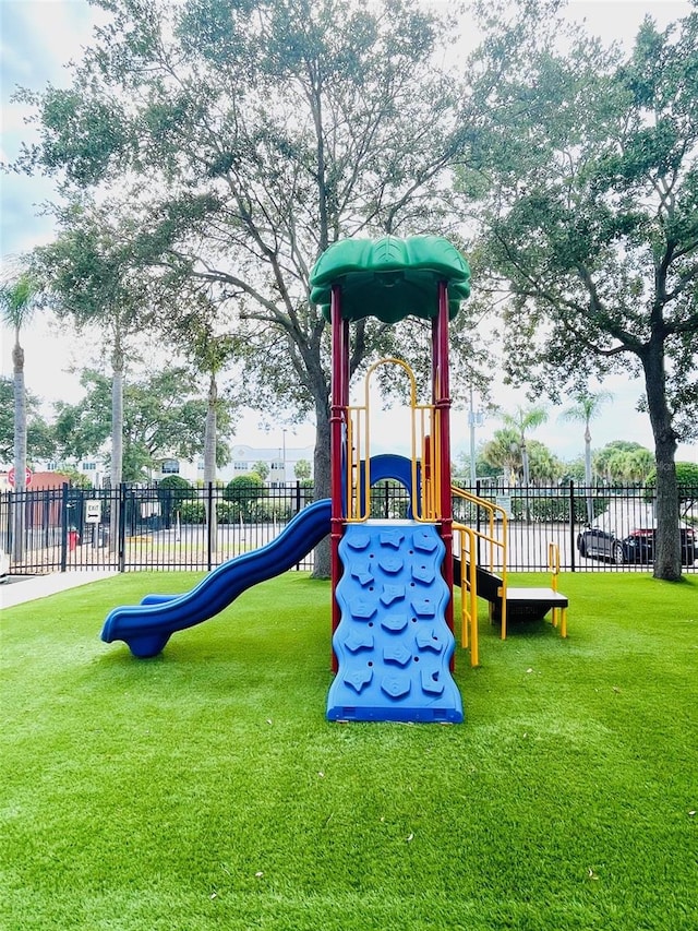 view of jungle gym with a lawn