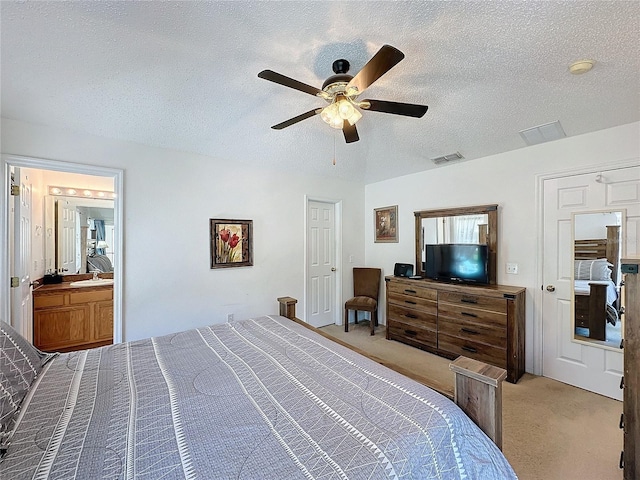 carpeted bedroom with ceiling fan and a textured ceiling