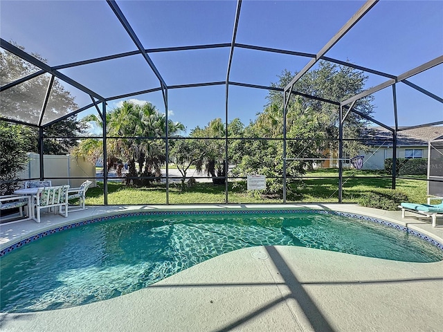 view of swimming pool featuring glass enclosure and a patio