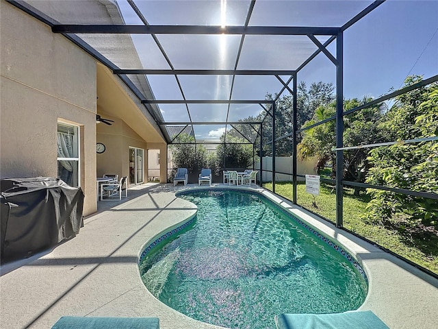 view of pool with a patio, a lanai, and ceiling fan