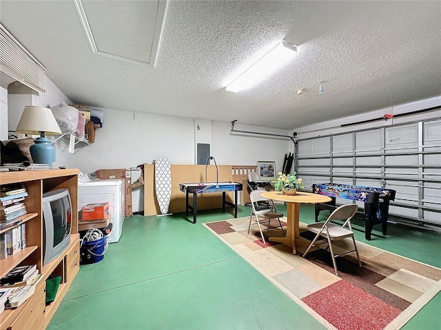 garage with washer / clothes dryer, electric panel, and a trampoline