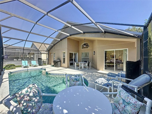 back of property featuring a patio, ceiling fan, and a lanai