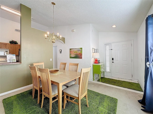 dining area featuring an inviting chandelier, carpet, lofted ceiling, and a textured ceiling