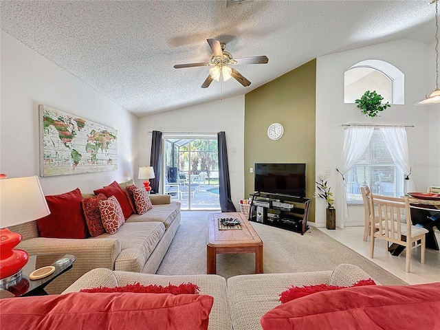 living room featuring ceiling fan, carpet flooring, a textured ceiling, and lofted ceiling