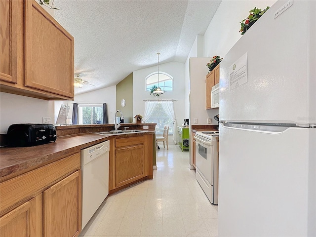 kitchen with sink, white appliances, a textured ceiling, and decorative light fixtures