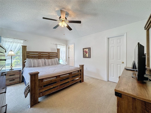 carpeted bedroom with a textured ceiling and ceiling fan