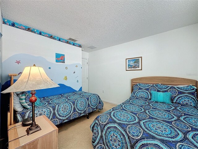 bedroom featuring carpet and a textured ceiling