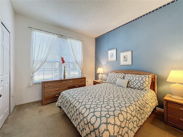 bedroom with carpet flooring and a textured ceiling