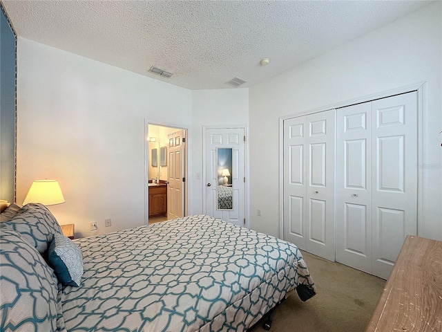 carpeted bedroom with a closet and a textured ceiling