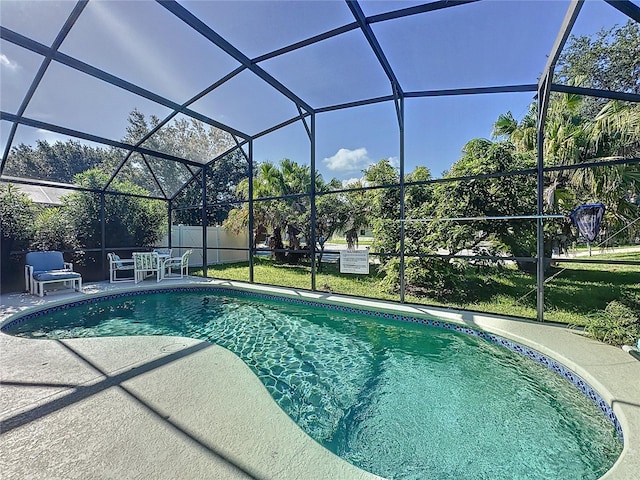 view of swimming pool with a patio area and a lanai