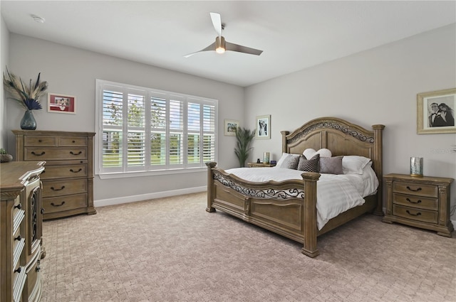 bedroom with ceiling fan and light carpet