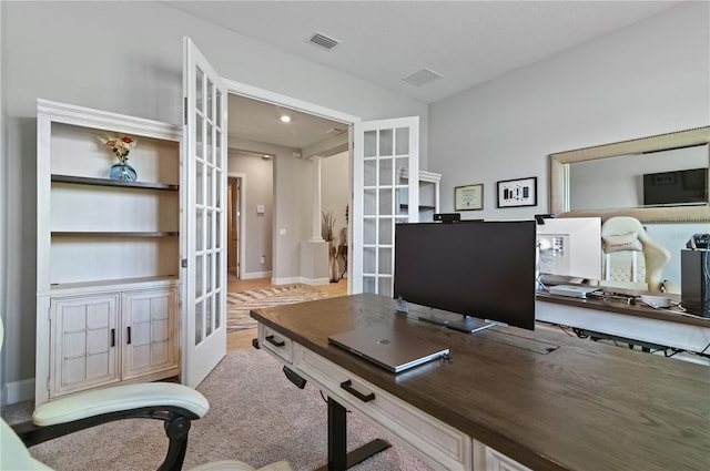 carpeted office featuring french doors