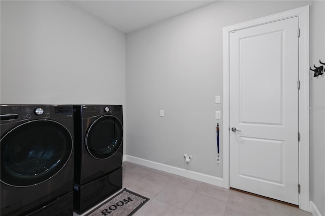 clothes washing area featuring light tile patterned flooring and independent washer and dryer