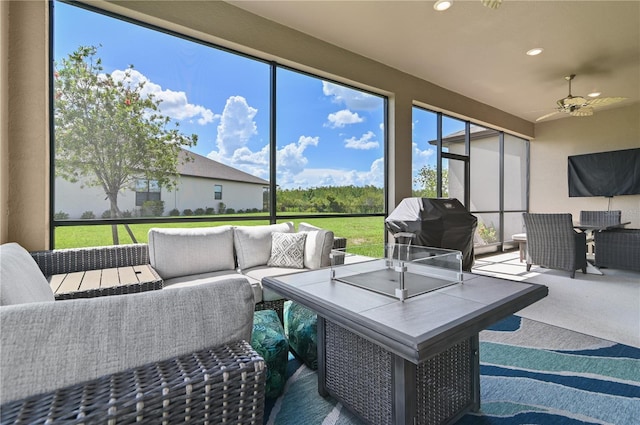 sunroom featuring ceiling fan