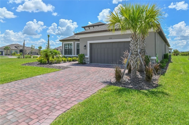 view of front of property with a garage and a front lawn