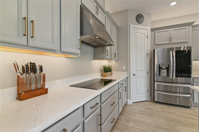 kitchen with black electric cooktop, gray cabinets, and stainless steel refrigerator with ice dispenser